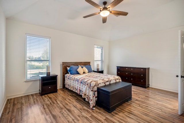 bedroom with lofted ceiling, light wood-type flooring, and ceiling fan