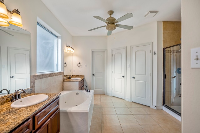 bathroom featuring vanity, plenty of natural light, tile patterned flooring, and plus walk in shower