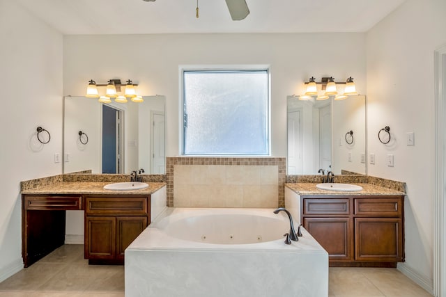 bathroom featuring vanity, tiled tub, and tile patterned flooring