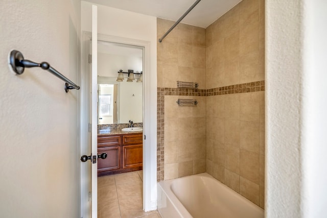 bathroom with vanity, tile patterned flooring, and tiled shower / bath