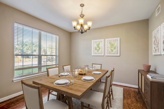 dining room featuring an inviting chandelier and dark hardwood / wood-style floors