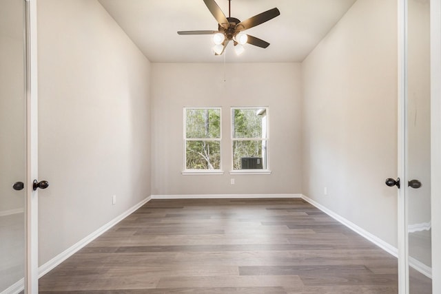 spare room featuring hardwood / wood-style floors and ceiling fan