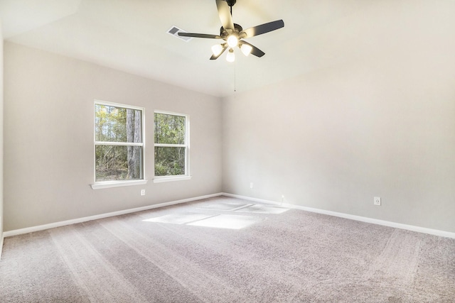 carpeted spare room with ceiling fan