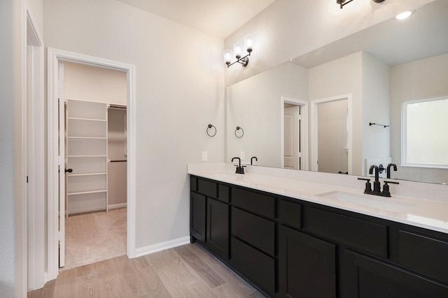 bathroom with vanity and hardwood / wood-style flooring