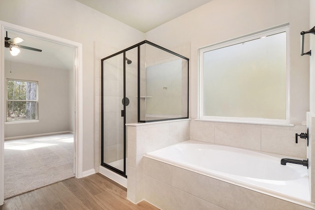 bathroom featuring wood-type flooring, separate shower and tub, and ceiling fan