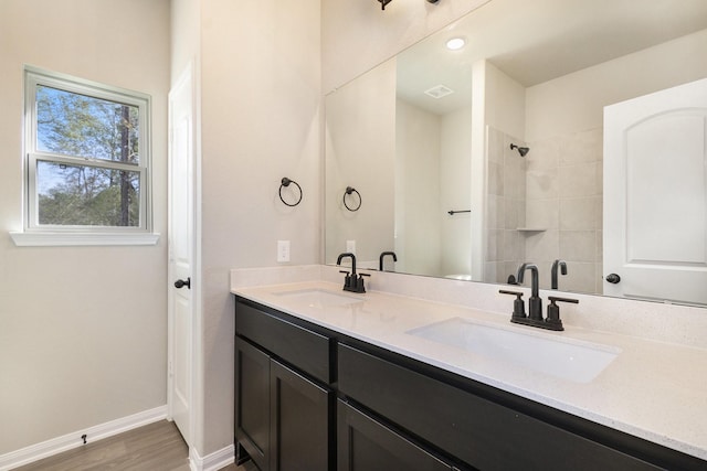 bathroom with vanity, wood-type flooring, and walk in shower