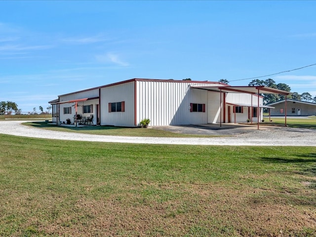 exterior space with a carport and a front lawn