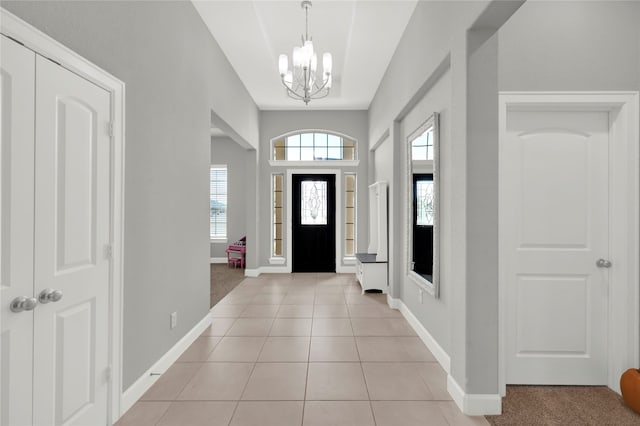 entrance foyer with a chandelier and light tile patterned floors