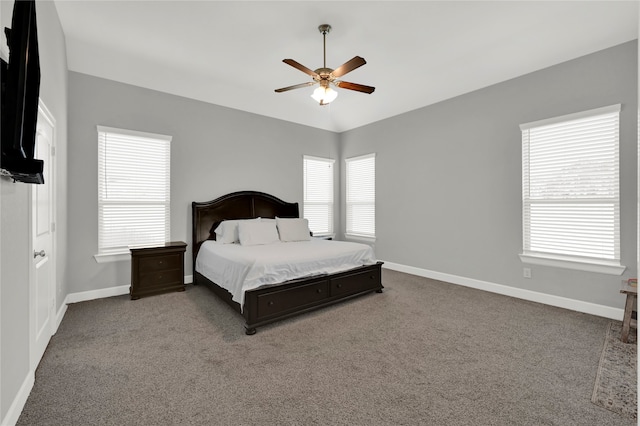 carpeted bedroom featuring ceiling fan and multiple windows