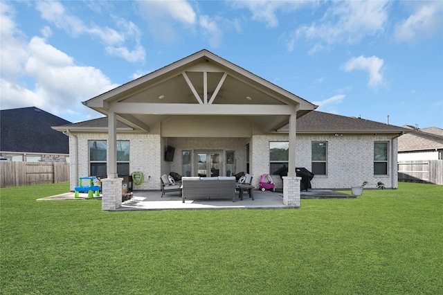 back of property featuring a patio area, outdoor lounge area, and a lawn