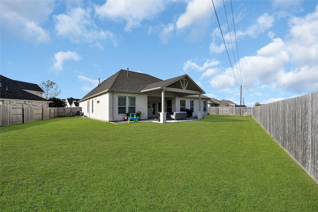 back of house featuring a patio and a lawn