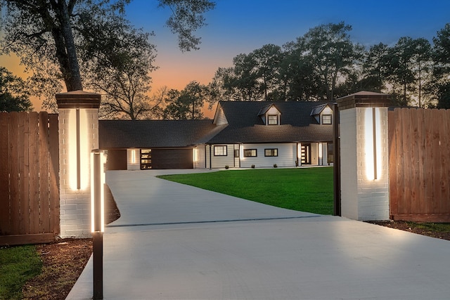 view of front of property featuring a yard and a garage