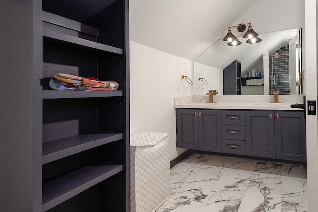 bathroom featuring vanity and vaulted ceiling