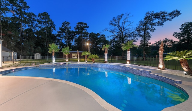 pool at dusk with a patio and a lawn