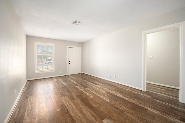 empty room featuring dark wood-type flooring