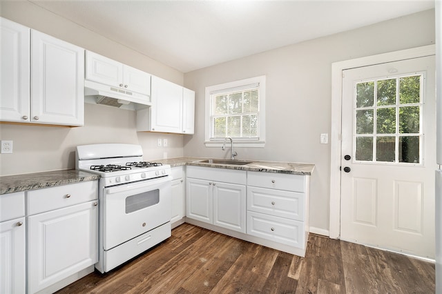 kitchen with white gas range, a healthy amount of sunlight, white cabinetry, and sink