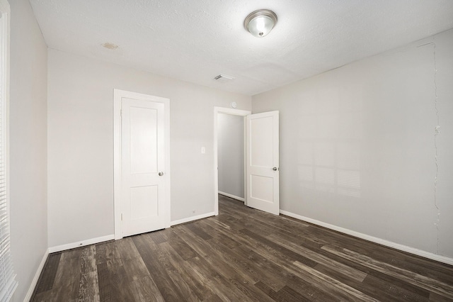10406 Wiggins St, Houston, TX 77029 - unfurnished bedroom featuring dark wood-style flooring and baseboards
