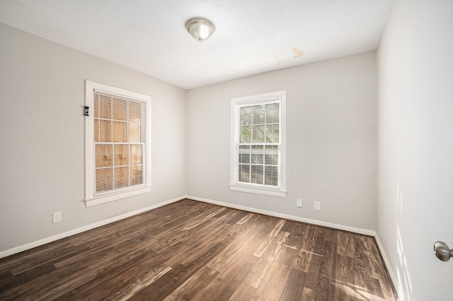 unfurnished room featuring dark wood-type flooring