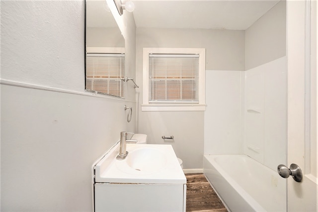 bathroom featuring vanity, hardwood / wood-style floors, and shower / tub combination