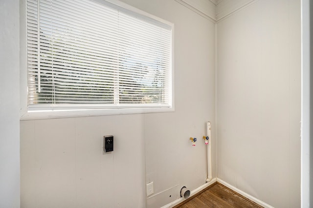 laundry area with electric dryer hookup and wood-type flooring