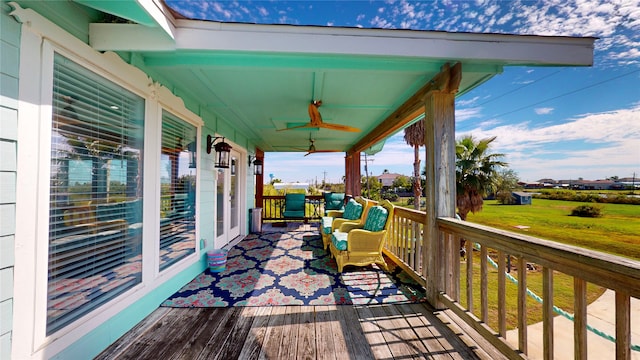 wooden terrace featuring ceiling fan