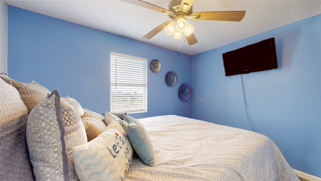 bedroom with a textured ceiling and ceiling fan