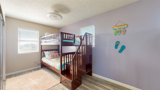 bedroom featuring hardwood / wood-style flooring and a textured ceiling