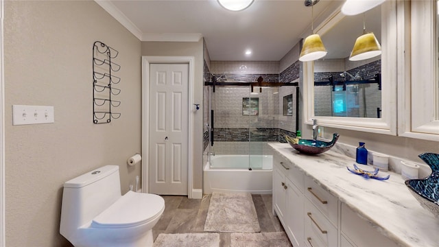 full bathroom featuring shower / bath combination with glass door, toilet, vanity, hardwood / wood-style flooring, and ornamental molding