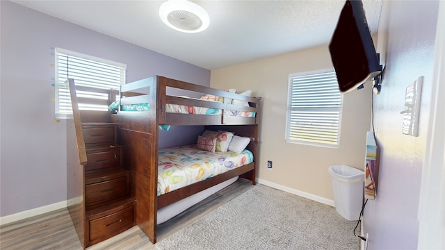 carpeted bedroom with multiple windows