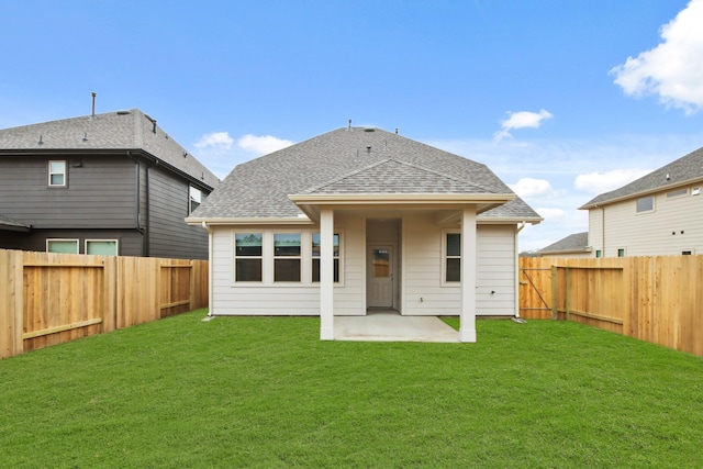 back of property featuring a lawn and a patio area