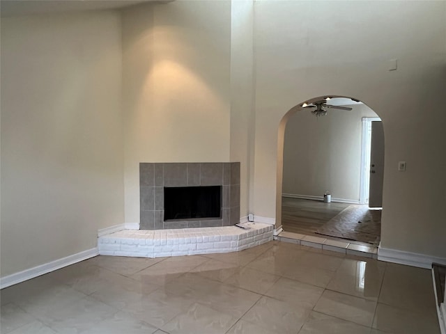 unfurnished living room with ceiling fan