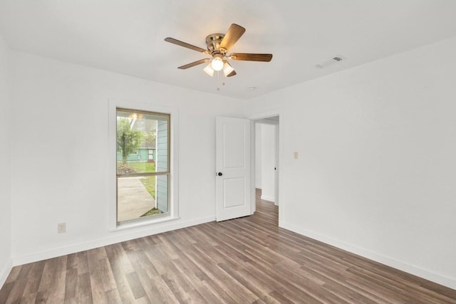 spare room with ceiling fan and wood-type flooring