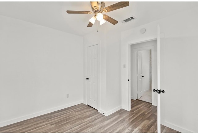 empty room featuring ceiling fan and wood-type flooring