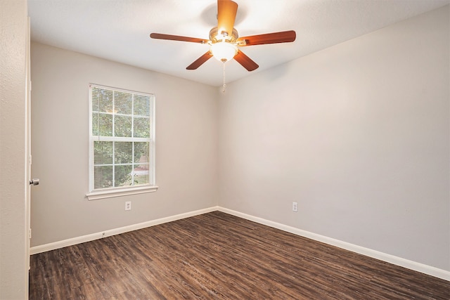 unfurnished room featuring dark wood-type flooring and ceiling fan