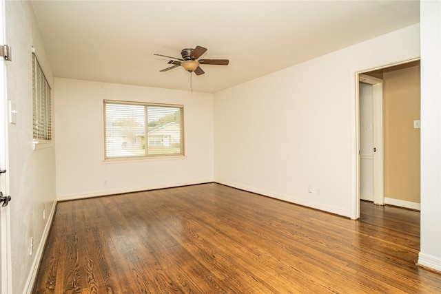 unfurnished room featuring ceiling fan and dark wood-type flooring