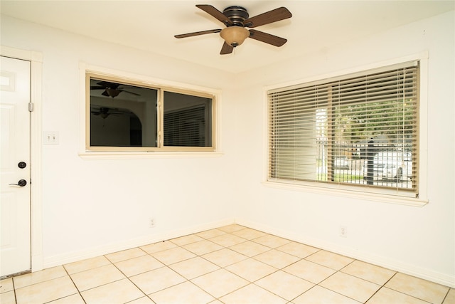 tiled empty room with ceiling fan