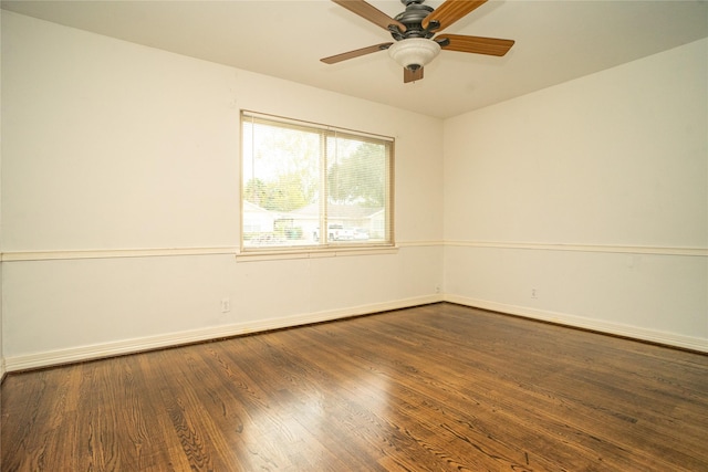 empty room with ceiling fan and dark wood-type flooring