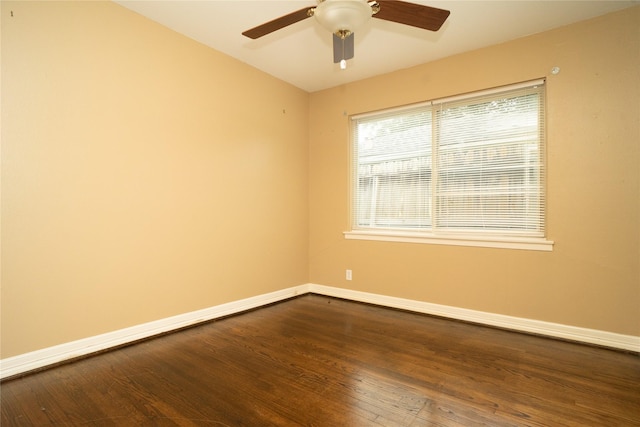 empty room with ceiling fan and dark hardwood / wood-style floors