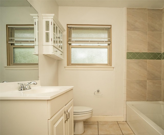 full bathroom with tile patterned flooring, vanity, tiled shower / bath combo, and toilet