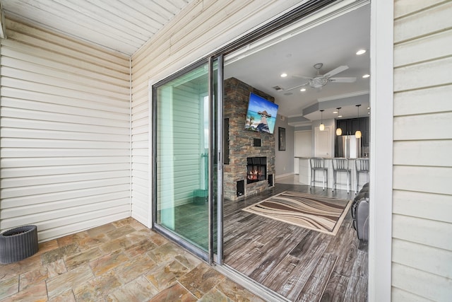 interior space with ceiling fan and a fireplace