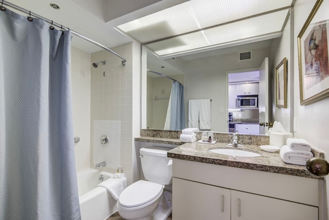 full bathroom featuring vanity, shower / bath combo, and toilet