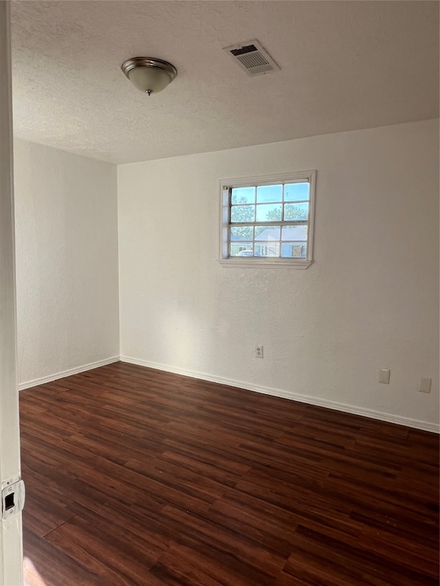 unfurnished room with dark hardwood / wood-style floors