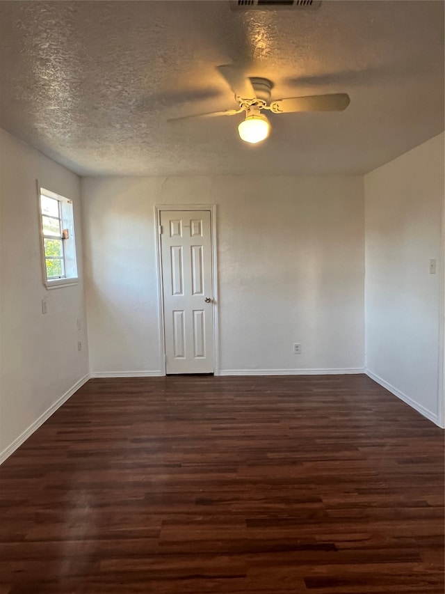 unfurnished room featuring ceiling fan, a textured ceiling, and dark hardwood / wood-style flooring