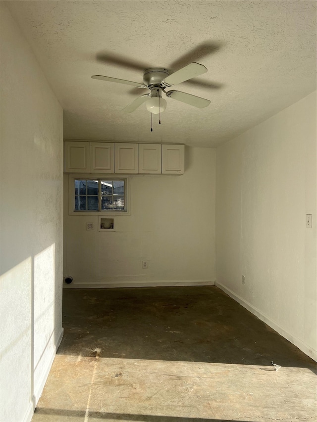 spare room with a textured ceiling and ceiling fan