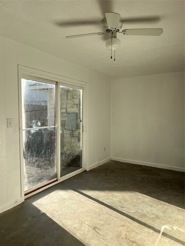 spare room featuring a textured ceiling and ceiling fan