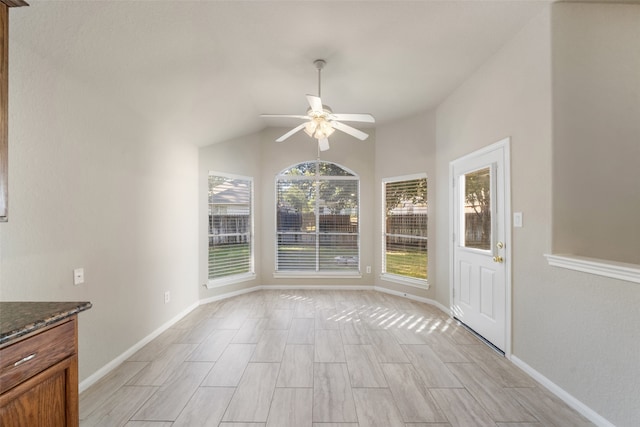 unfurnished dining area featuring vaulted ceiling, light wood-type flooring, and ceiling fan