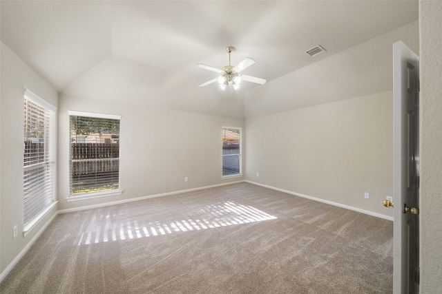 carpeted spare room featuring lofted ceiling and ceiling fan