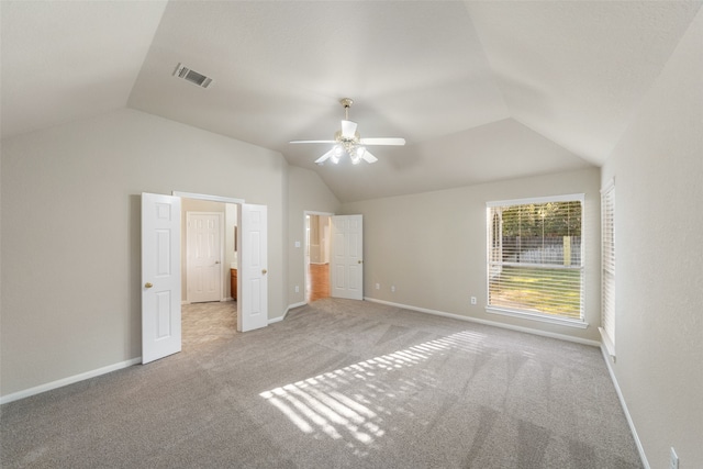 unfurnished bedroom featuring light carpet, vaulted ceiling, and ceiling fan