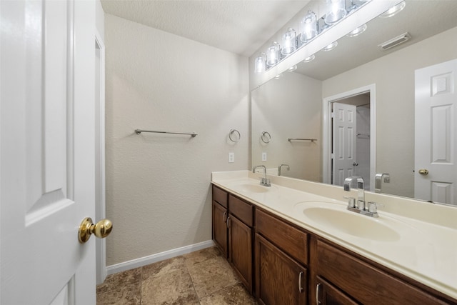 bathroom featuring vanity and a textured ceiling