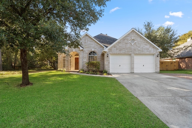 view of front of property featuring a front yard and a garage